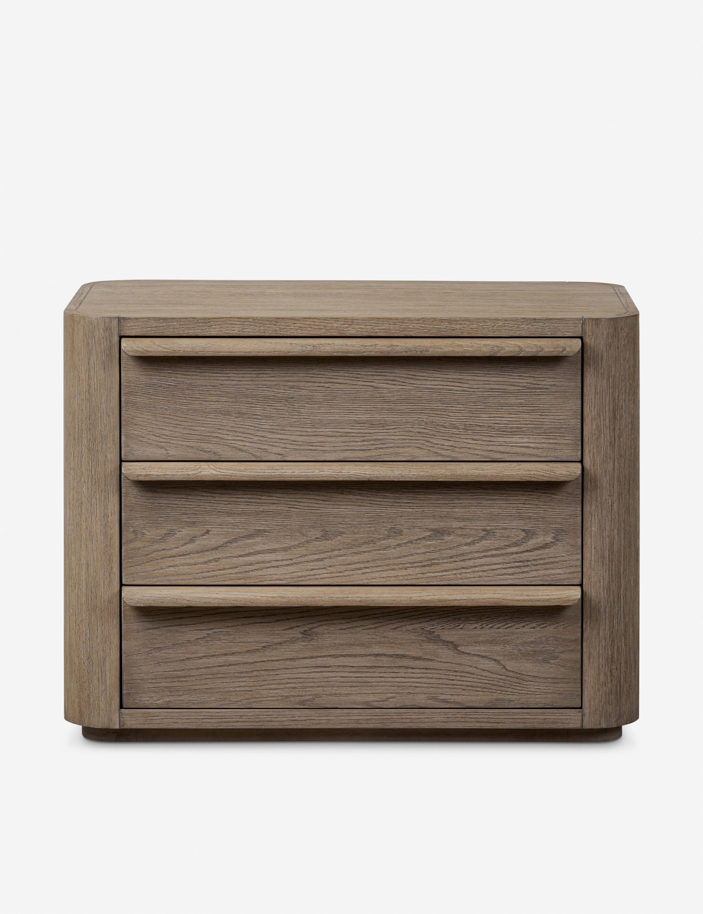 Table de chevet - Une étude d'impact doux, la table de chevet présente des coins arrondis et de larges tiroirs coulissants pour une version raffinée du chevet.
