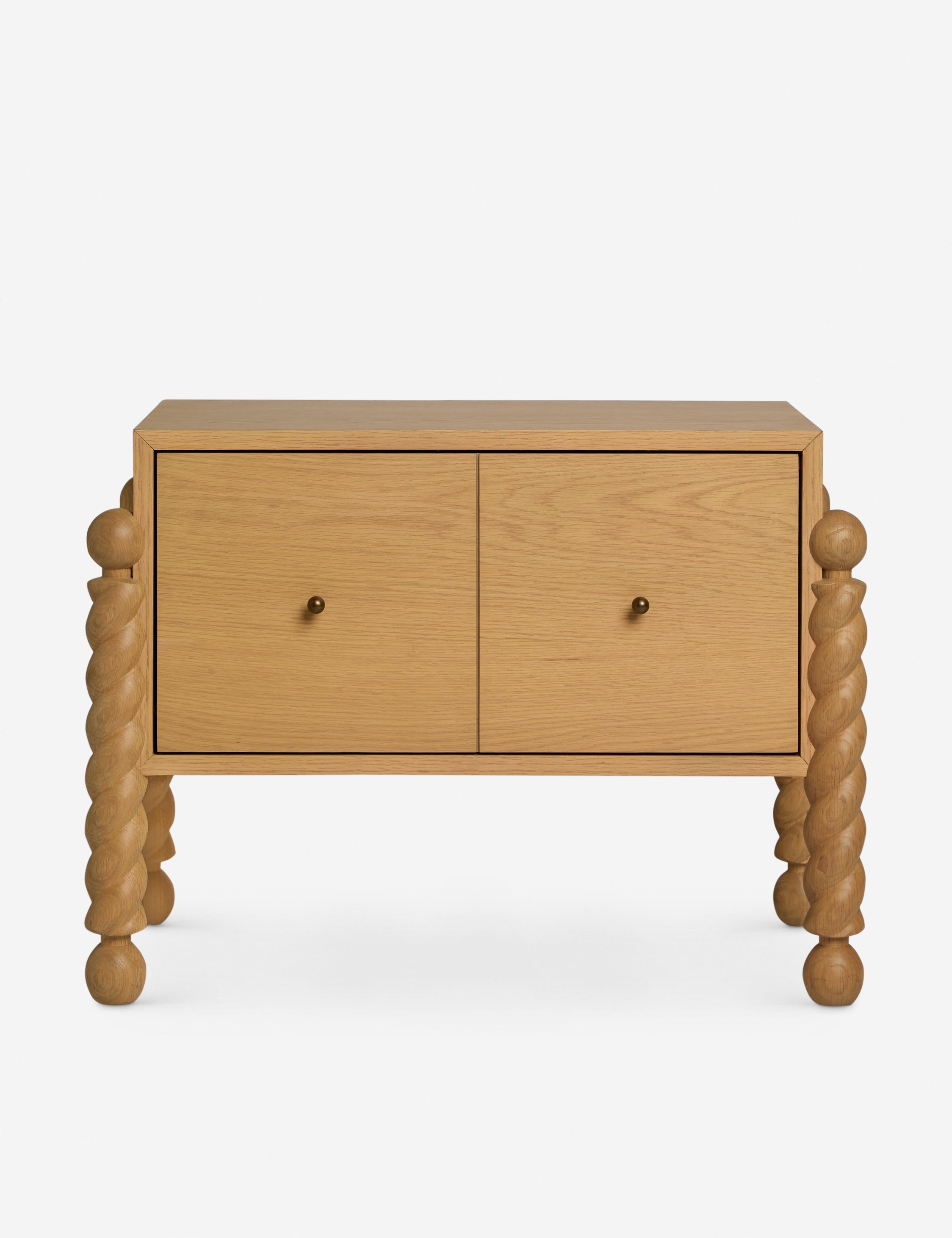 Table de chevet - Alliant avec raffinement formes et lignes, la table de chevet présente des pieds tournés sculpturaux qui encadrent une structure aux lignes épurées