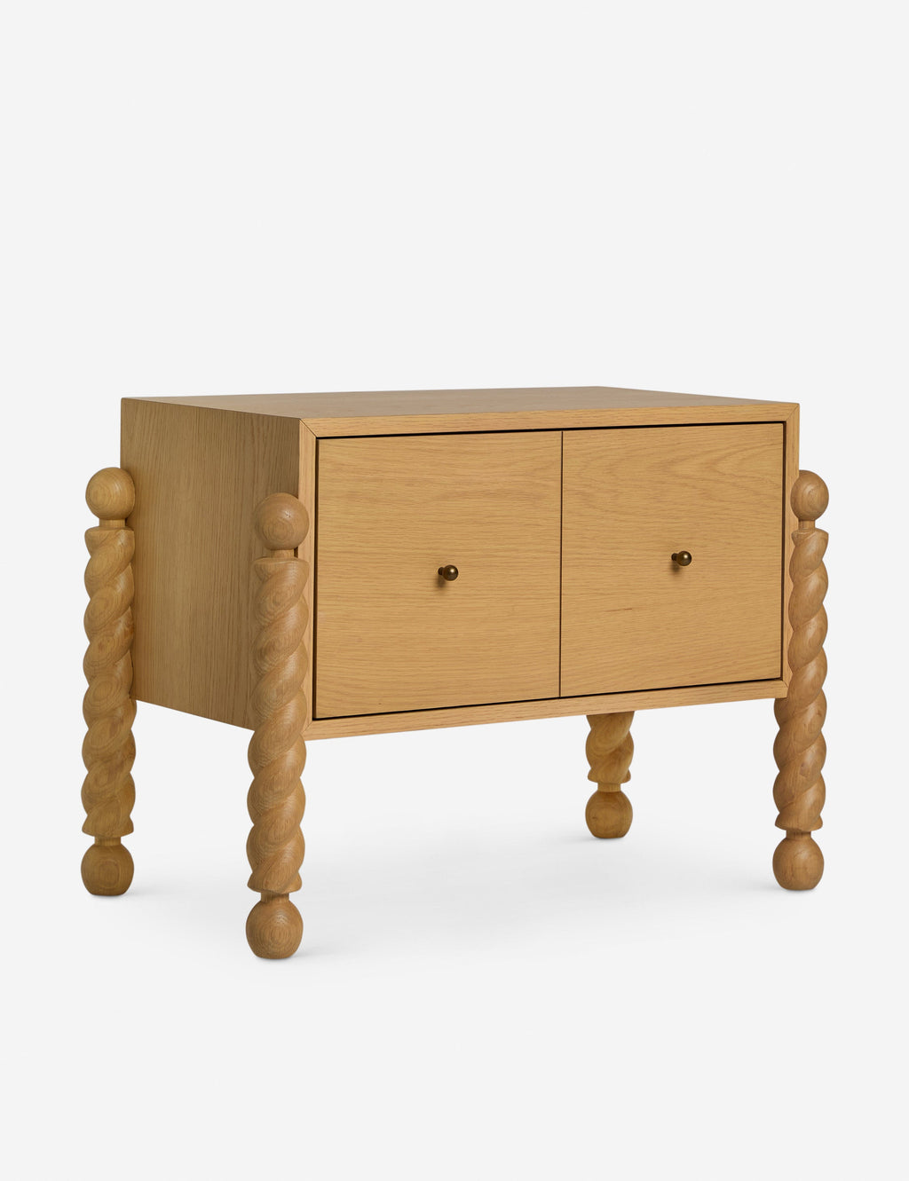 Table de chevet - Alliant avec raffinement formes et lignes, la table de chevet présente des pieds tournés sculpturaux qui encadrent une structure aux lignes épurées