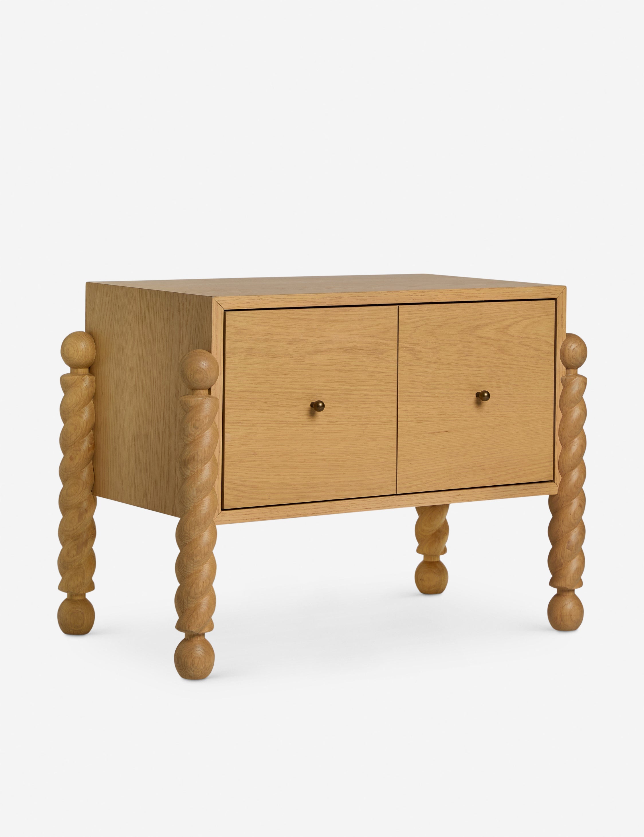 Table de chevet - Alliant avec raffinement formes et lignes, la table de chevet présente des pieds tournés sculpturaux qui encadrent une structure aux lignes épurées
