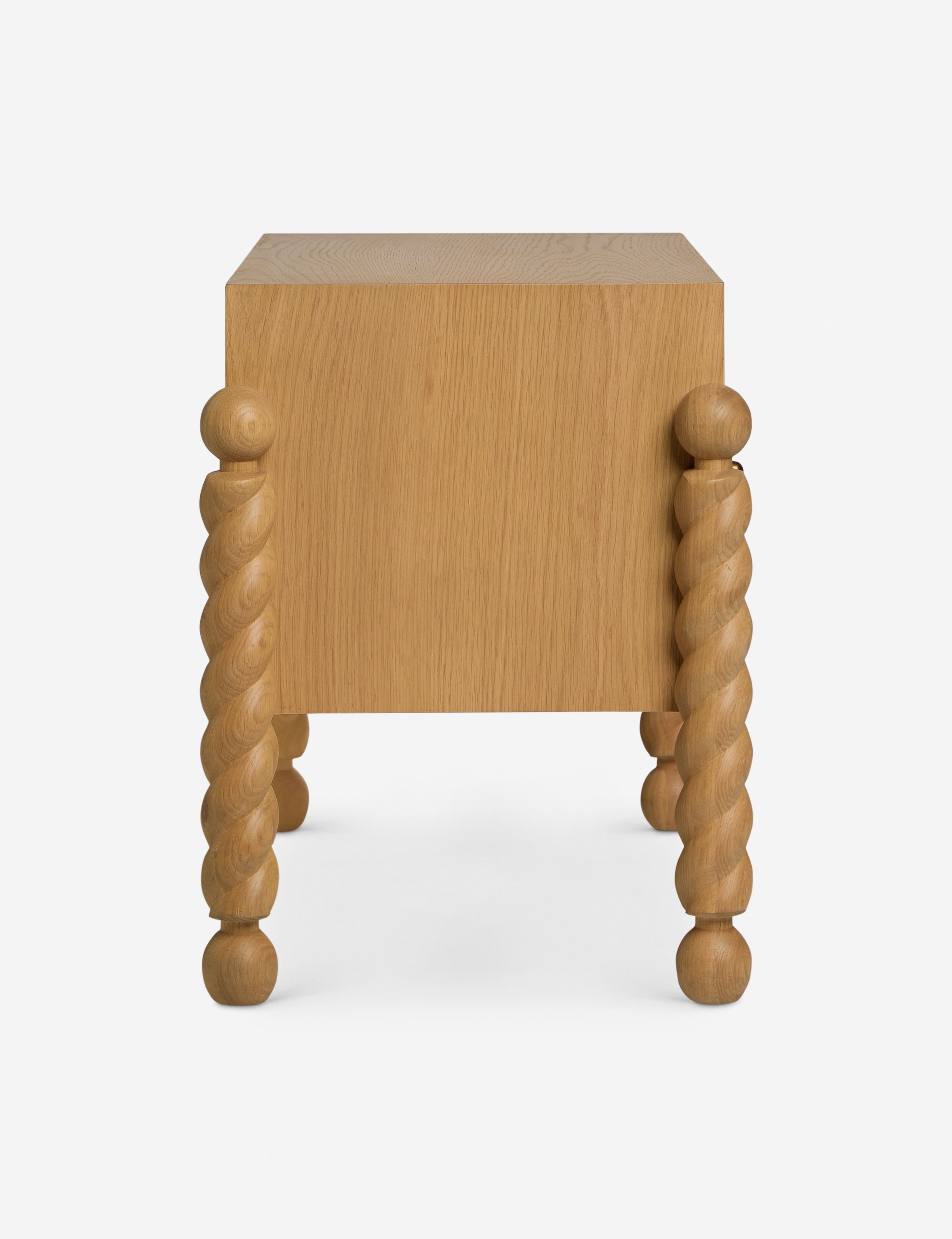 Table de chevet - Alliant avec raffinement formes et lignes, la table de chevet présente des pieds tournés sculpturaux qui encadrent une structure aux lignes épurées