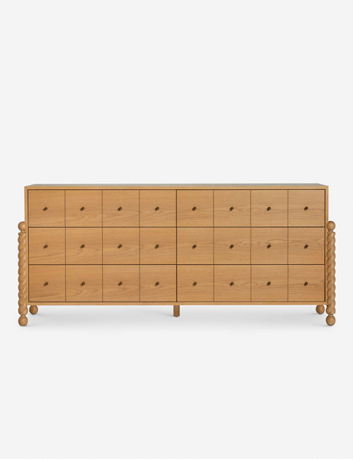 Commode à 6 tiroirs - Avec un mélange raffiné de formes et de lignes, cette commode présente des pieds tournés sculpturaux qui encadrent un caisson aux lignes épurées