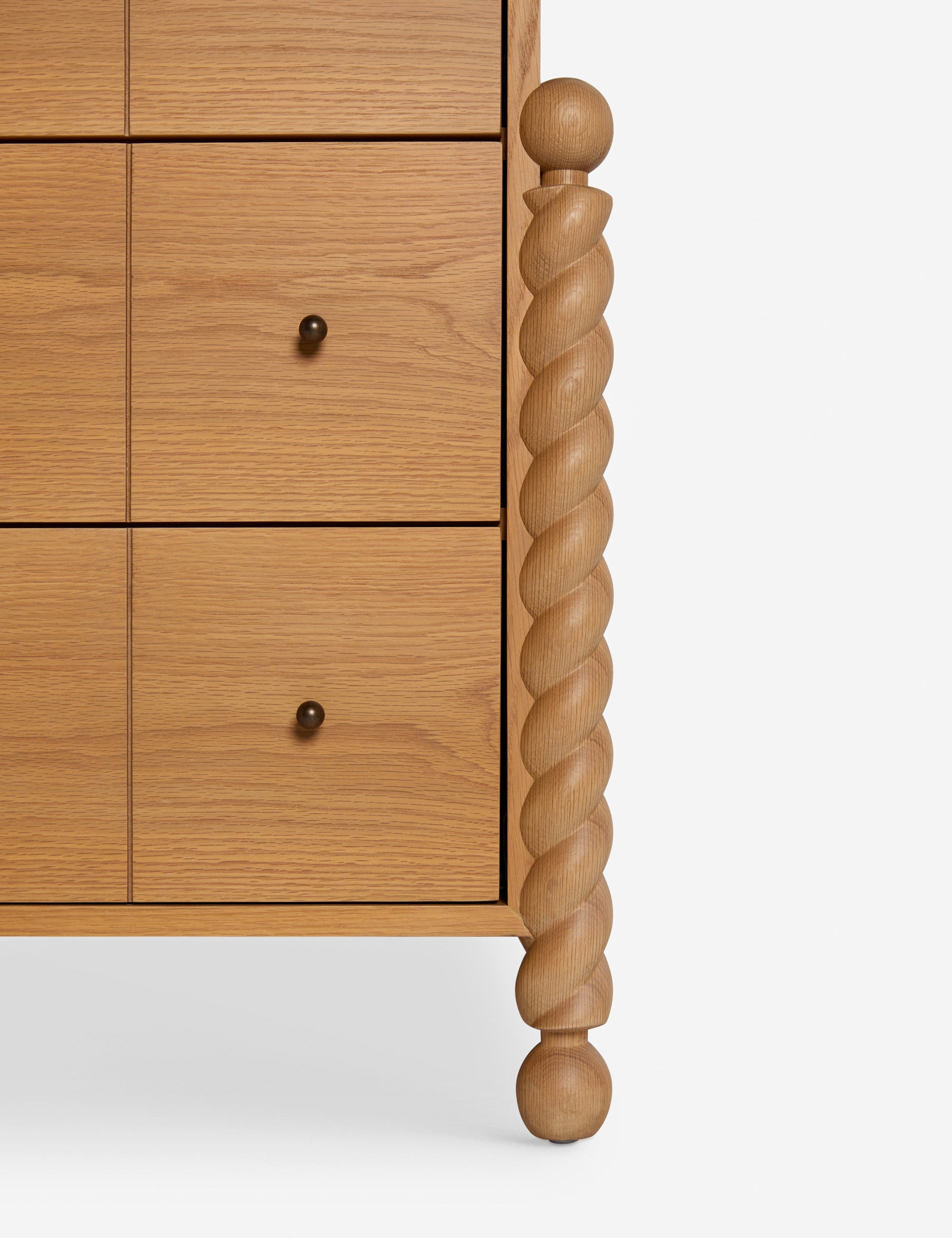 Commode à 6 tiroirs - Avec un mélange raffiné de formes et de lignes, cette commode présente des pieds tournés sculpturaux qui encadrent un caisson aux lignes épurées